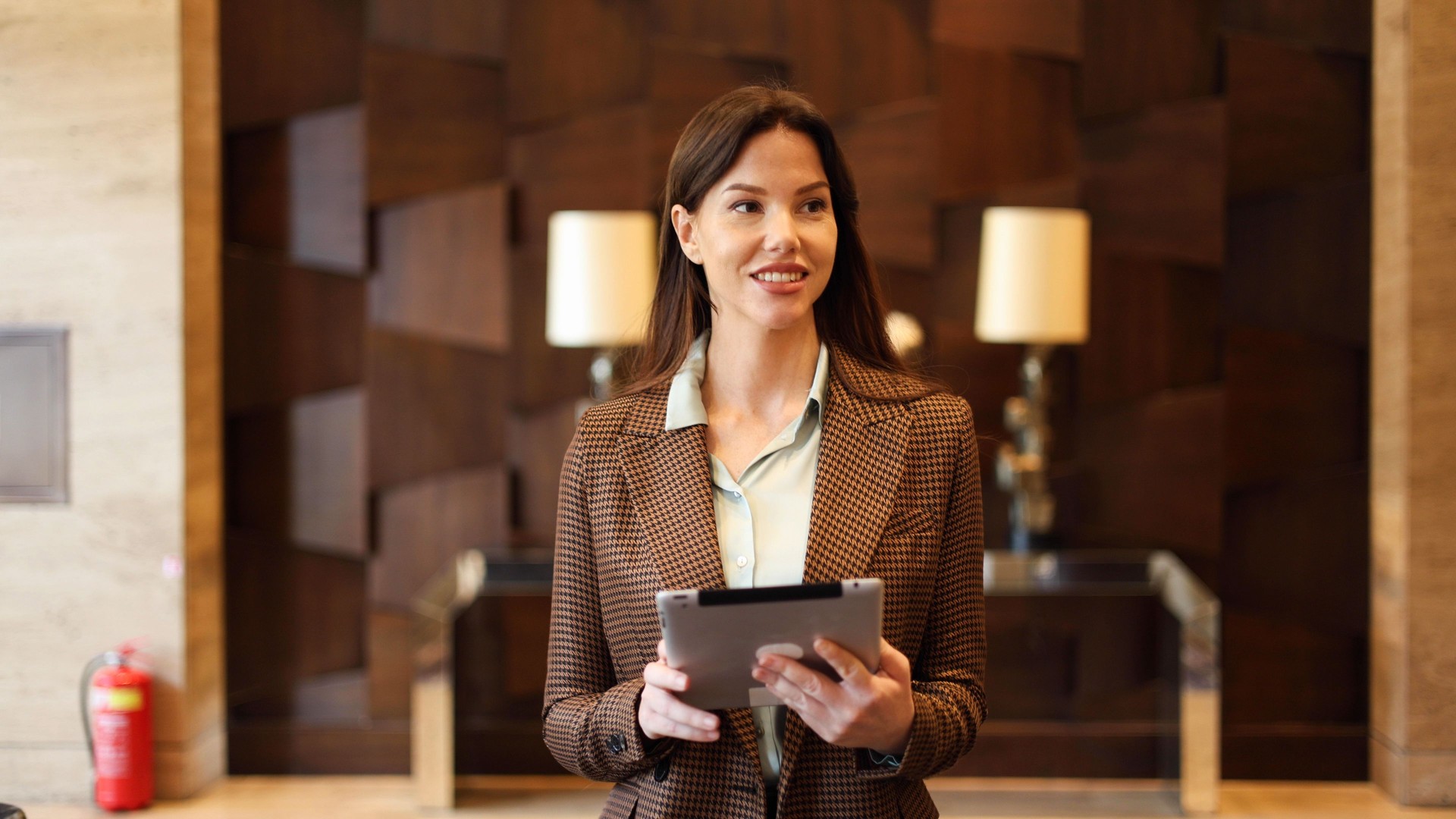 Confident businesswoman using tablet at the company lobby