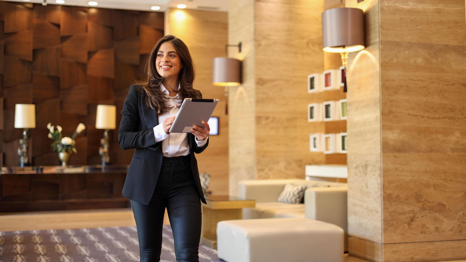 Confident businesswoman using tablet at the company lobby