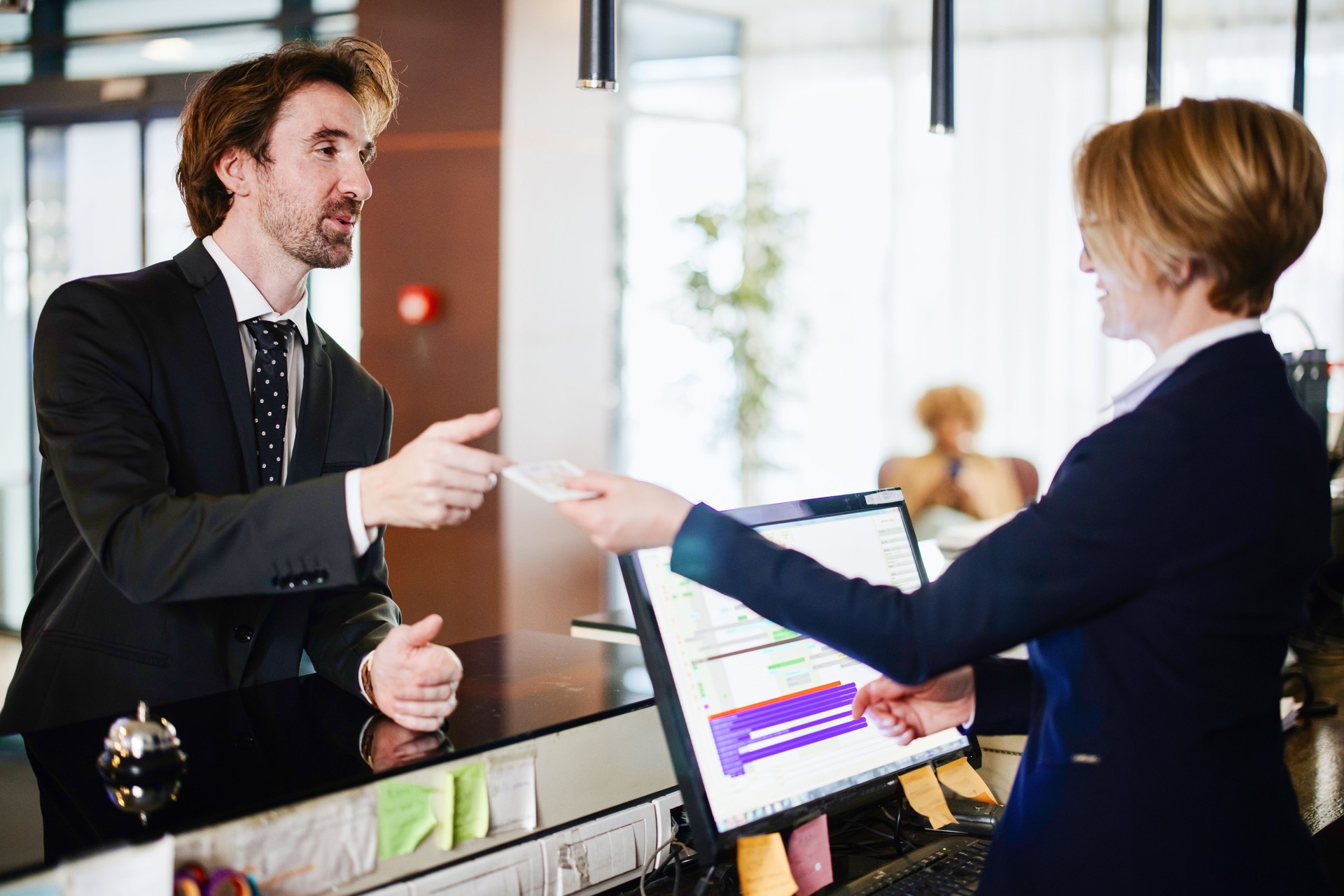 Businessman at the reception of a hotel checking in
